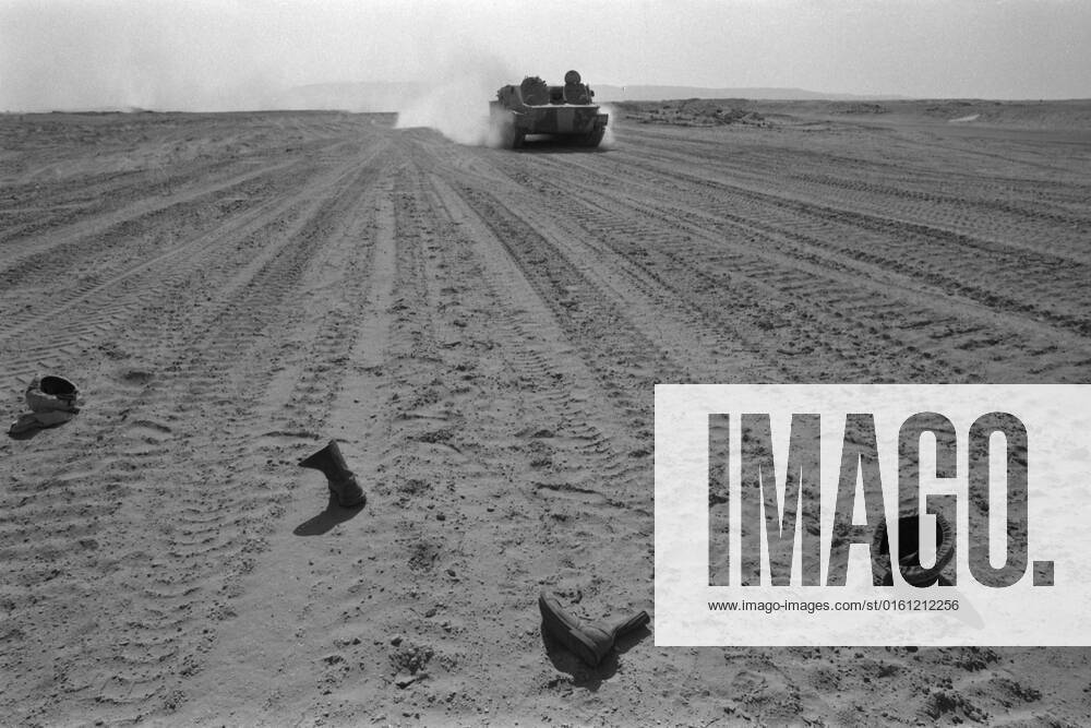 Boots and steel helmets lie in the sands of Sinai, in the background a rifle tank, amphibious tank, during the Yom Kippur War, the Yom Kippur War between Israel and the Arab states of Egypt, Jordan and Syria lasted from October 6 to October 25, 1973,
