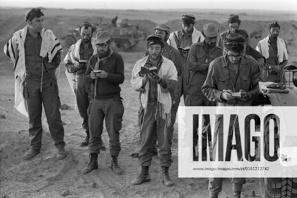 Israeli soldiers stand and pray, Judaism, Jewish faith, religion, during the Yom Kippur War, the Yom Kippur War between Israel and the Arab states of Egypt, Jordan and Syria lasted from October 6 to October 25, 1973,