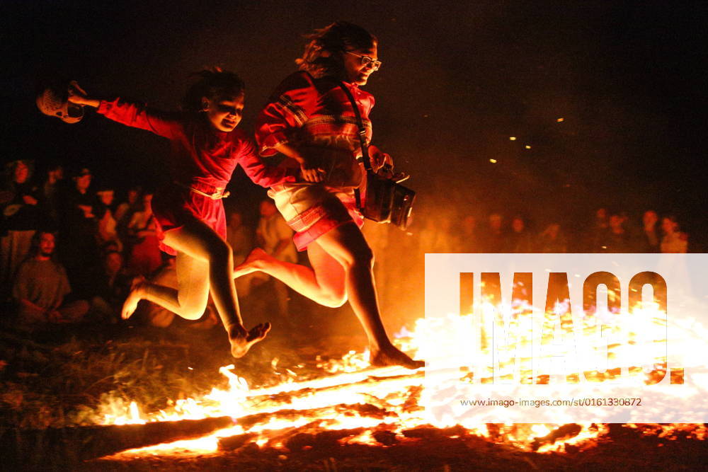 OMSK REGION, RUSSIA – JUNE 21, 2022: People leap over flames at the Solntsestoyaniye Solstice Festival in the village of Okunevo. The festival s programme includes masterclasses in arts and crafts, lectures, a crafts fair, live music performances, performances by dance and music collectives, games, dances, etc. Yevgeny Sofiychuk TASS TS1373EB