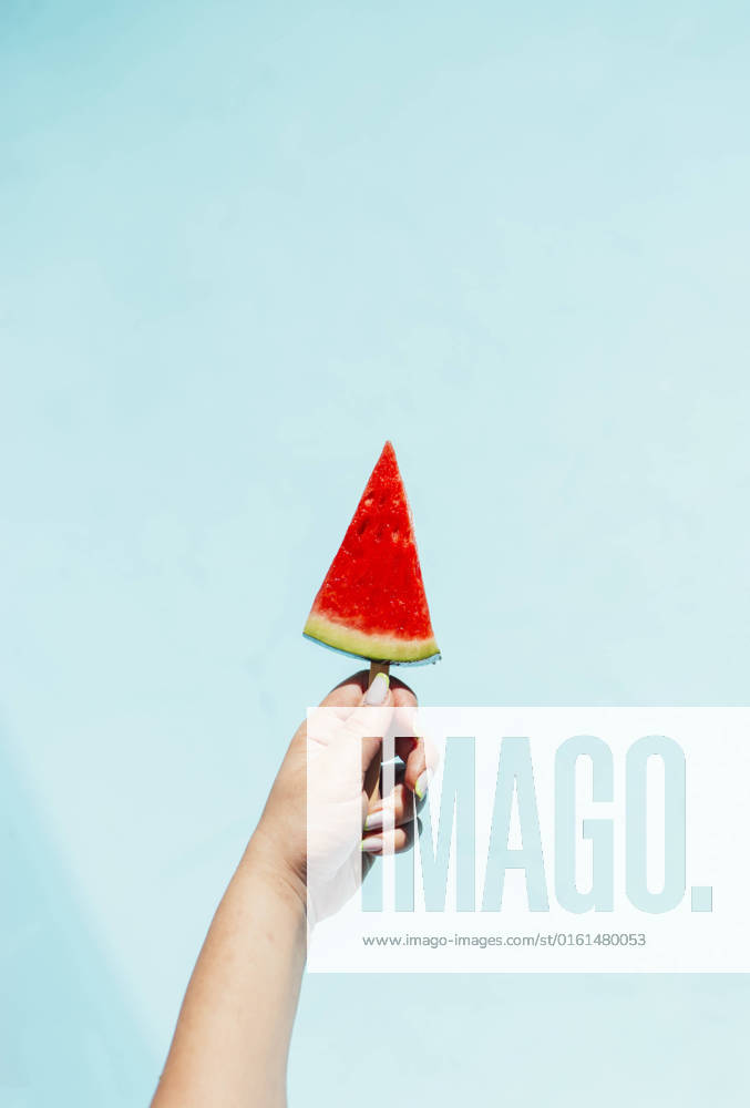 Hand of woman holding watermelon slice with pospsicle stick model released, Symbolfoto, EGHF00447
