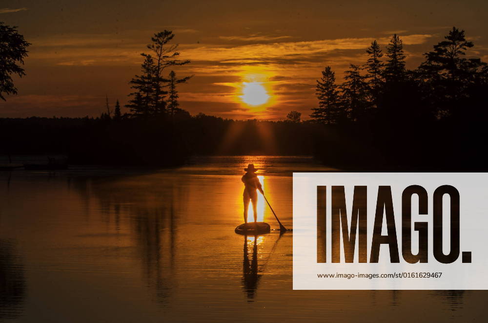 A paddle boarder greets the dawn on Pigeon Lake in city of Kawartha Lakes, Ontario on Sunday, June 26, 2022. With the summer solstice having just passed we are still in for some of the longest days of the year until the end of July. KAWARTHA LAKES CANADA - ZUMAc35_ 20220626_zaf_c35_024