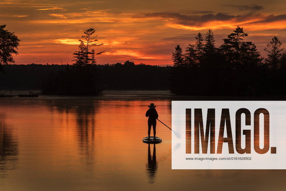 A paddle boarder greets the dawn on Pigeon Lake in city of Kawartha Lakes, Ontario on Sunday, June 26, 2022. With the summer solstice having just passed we are still in for some of the longest days of the year until the end of July. KAWARTHA LAKES CANADA - ZUMAc35_ 20220626_zaf_c35_025