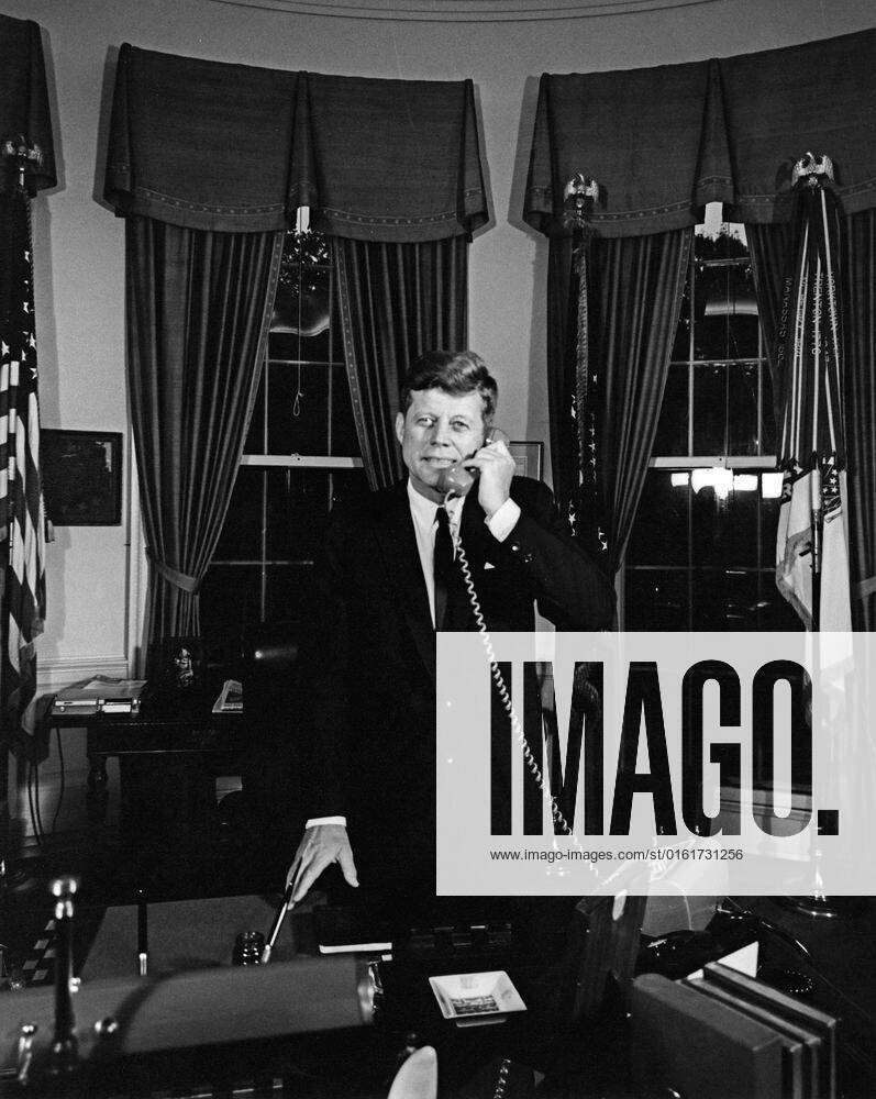 President Kennedy telephones Astronaut Gordon Cooper aboard USS Kearsarge (CVS-33), after recovery of Faith 7. President John F. Kennedy (standing at his desk) speaks on the telephone with astronaut, Major L. Gordon Cooper, following the successful completion of Major Coopers Mercury-Atlas 9 orbital flight, as part of the final manned space mission of the National Aeronautics and Space Administrations (NASA) Project Mercury program. Major Cooper was aboard the USS Kearsarge (CVS-33) after splashdown and recovery of the Mercury capsule (also known as Faith 7) in the Pacific Ocean. Oval Office, White House, Washington, D.C.