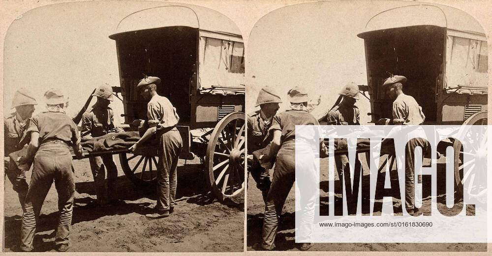 Boer War: a casualty of the Battle of Modder River being loaded onto an ambulance. Photograph by Underwood & Underwood, 1900.