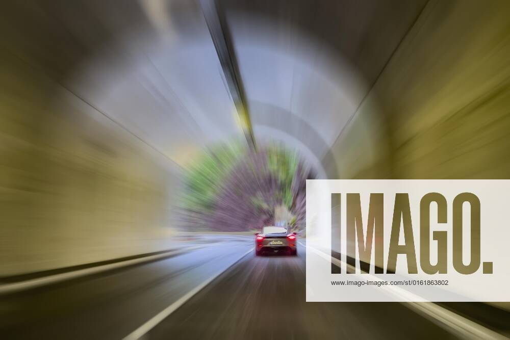 Raser Drivers in Sports car Rest at faster Trip with superelevated Speed drives through Tunnel, France, Europe