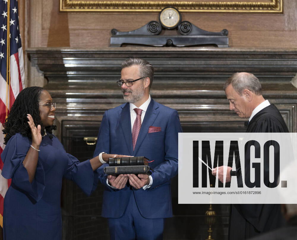 Chief Justice John Roberts (R) administers the Judicial Oath to U.S. Supreme Court Associate Justice Ketanji Brown Jackson as her husband Patrick Jackson holds the Bible in the East Conference Room of the Supreme Court Building in Washington, DC on Thursday, June 30, 2022. Photo Courtesy of the Collection of the Supreme Court of the United States WAX20220630327 BONNIExCASH