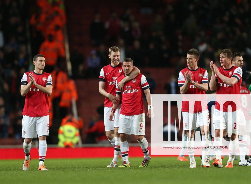 Arsenal s Lukas Podolski celebrates at the final whistle with Per Mertesacker Arsenal vs West Ham United- Barclays Premier League - Emirates Stadium - London - England - 15 04 2014 - Pic David Klein Sportimage .
