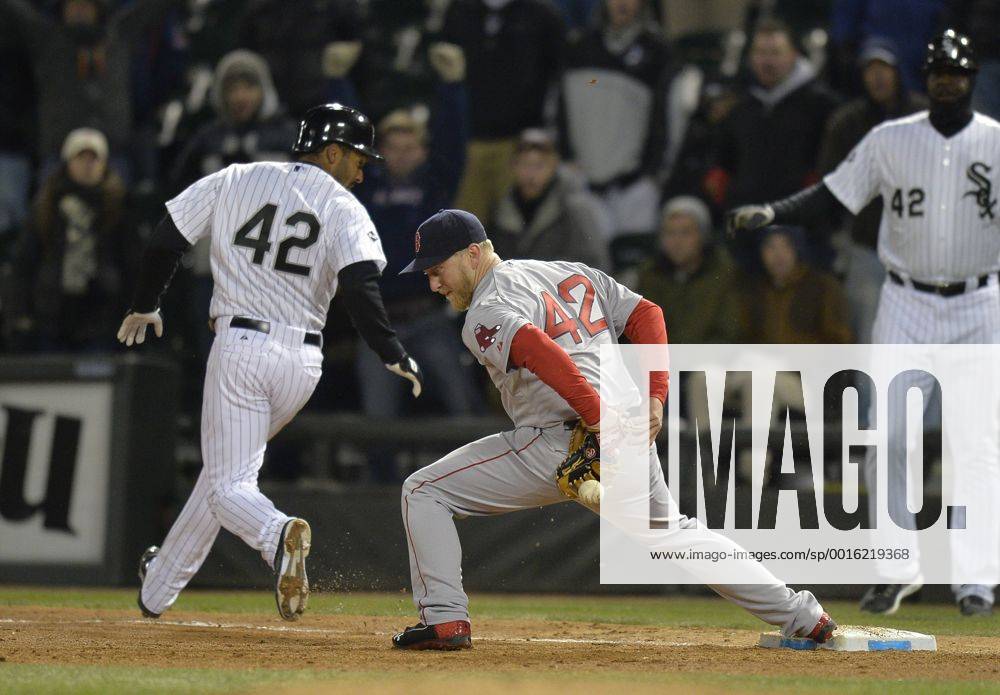 Boston Red Sox first baseman Mike Carp (R) cannot get to a bad throw by shortstop Xander Bogaerts as Chicago White Sox s Marcus Semien reaches safely on the throwing error during the ninth inning at U.S. Cellular Field on April 15, 2014 in Chicago. The error allowed Alexei Ramirez to score the winning run. The White Sox defeated the Red Sox 2-1. CHI2014041520