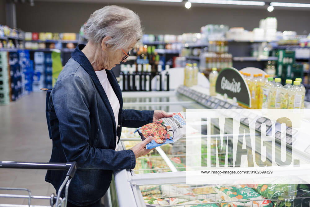 Old woman buying frozen food in supermarket copyright Ute Grabowsky photothek Radevormwald Germany
