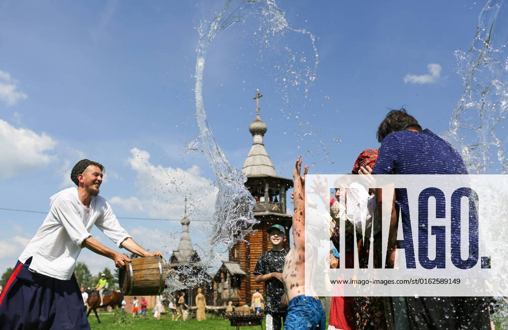 OMSK REGION, RUSSIA – JULY 10, 2022: Pouring water on people during festivities marking Ivan Kupala Day, a pagan summer solstice celebration, at the Starina Sibirskaya local history and culture open air museum in the village of Bolsherechye. Yevgeny Sofiychuk TASS TS139B54
