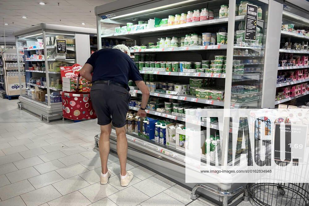 CONSUMER PRICES Inflation in Germany A man,customer stands in front of a refrigerated shelf and looks spellbound at the prices,price tag,price display,refrigerated counter,dairy products,shopping,inflation,consumer prices,inflation,