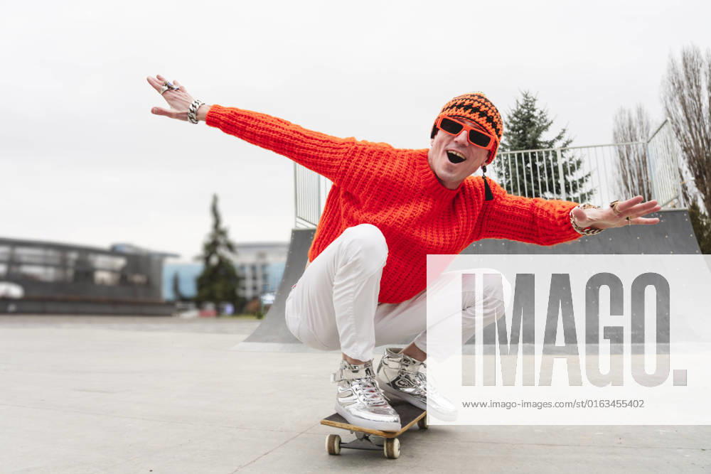 Happy mature man with arms outstretched enjoying on skateboard model released, Symbolfoto, OSF00153
