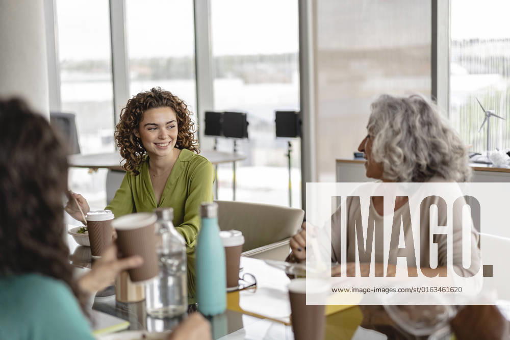Happy senior businesswoman having snacks with coworkers model released, Symbolfoto property released, JCICF00150