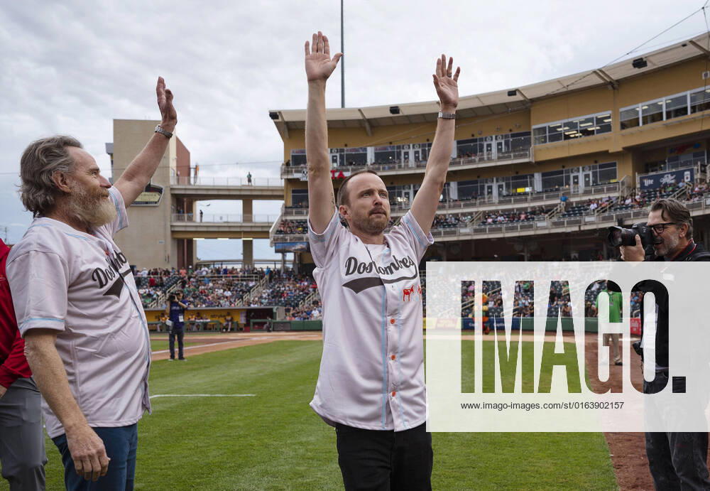 Breaking Bad actors Bryan Cranston and Aaron Paul wave to the crowd as they take the field for the first pitch before the Albuquerque Isotopes take on Las Vegas Aviators at the Rio Grande Credit Union Field at Isotopes Park in Albuquerque, N.M., on Saturday, July 30, 2022. USA - ZUMAab1_ 20220730_zaf_ab1_003