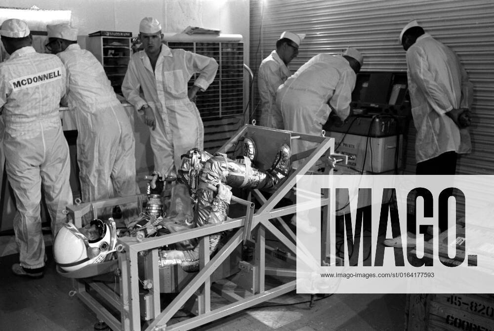 S62-05118 (1962) --- Astronaut L. Gordon Cooper Jr. on weight and balance scale in the White Room, Hanger S at Cape Canaveral.