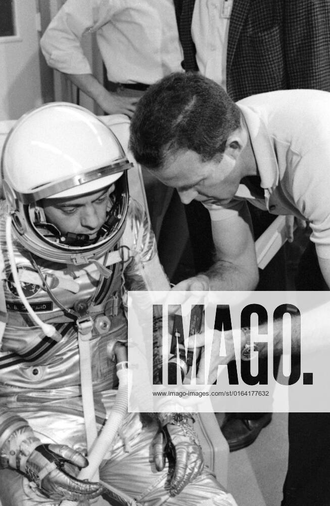 S63-03952 (1963) --- Astronaut L. Gordon Cooper Jr. explains the 16mm handheld spacecraft camera to his backup pilot astronaut Alan Shepard. The camera, designed by J.R. Hereford of McDonnell Aircraft Corp., will be used by Cooper during the Mercury-Atlas 9 (MA-9) mission to photograph experiments in space for M.I.T. and the Weather Bureau.