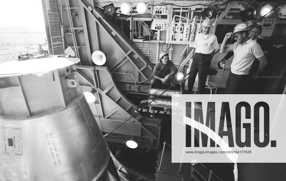 S63-03986 (1963) --- Astronaut L. Gordon Cooper Jr., prime pilot for the Mercury-Atlas 9 (MA-9) mission, and General Dynamics pad technicians watch Atlas 130D being hoisted into place in the gantry at pad 14, Cape Canaveral, Florida.