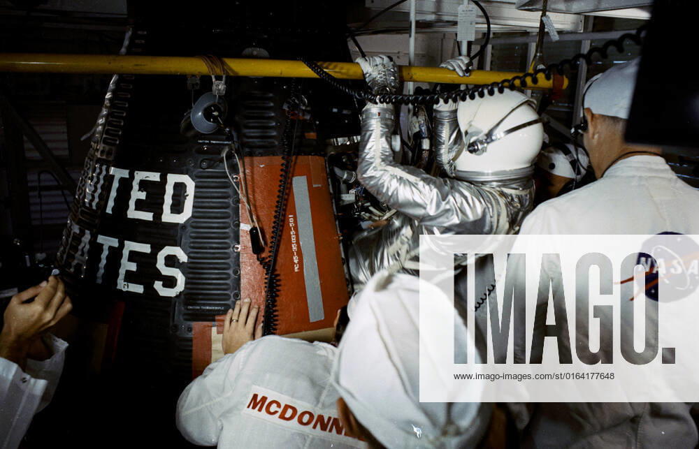 S63-07521 (15 May 1963) --- Astronaut L. Gordon Cooper Jr., pilot of the Mercury-Atlas 9 (MA-9) Earth-orbital space mission, is assisted into his Faith 7 Mercury spacecraft during the prelaunch countdown. MA-9 was launched on May 15, 1963, and the flight lasted for 34 hours and 20 minutes.