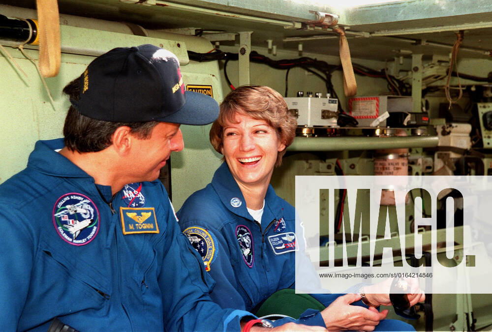 During emergency egress training inside an M-113 armored personnel carrier at the launch pad, Mission Specialist Michel Tognini of France and Commander Eileen M. Collins share a light moment. In preparation for their mission, the STS-93 crew are participating in Terminal Countdown Demonstration Test activities that also include a launch-day dress rehearsal culminating with a simulated main engine cut-off. Also at KSC are Pilot Jeffrey S. Ashby and Mission Specialists Steven A. Hawley (Ph.D.), and Catherine G. Coleman (Ph.D.). Collins is the first woman to serve as mission commander. Tognini represents the Centre National d Etudes Spatiales (CNES). The primary mission of STS-93 is the release of the Chandra X-ray Observatory, which will allo