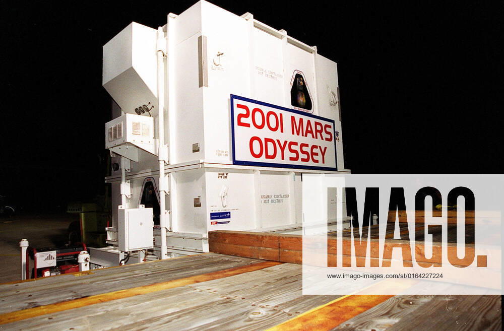 The 2001 Mars Odyssey spacecraft sits on the bed of the trailer that will take it from KSCs Shuttle Landing Facility to the Spacecraft Assembly and Encapsulation Facility 2 (SAEF-2) located in the KSC Industrial Area. The spacecraft arrived at the SLF aboard an Air Force C-17 cargo airplane that brought it from Denver, Colo.., location of the Lockheed Martin plant where the spacecraft was built. In the SAEF Odyssey will undergo final assembly and checkout. This includes installation of two of the three science instruments, integration of the three-panel solar array, and a spacecraft functional test. It will be fueled and then mated to an upper stage booster, the final activities before going to the launch pad. Launch is planned for April