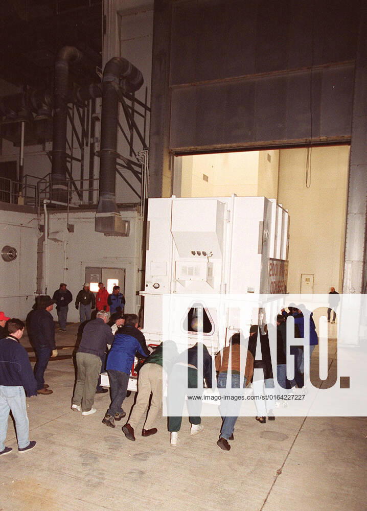 Workers push the crated 2001 Mars Odyssey spacecraft toward the Spacecraft Assembly and Encapsulation Facility 2 (SAEF-2) located in the KSC Industrial Area. The spacecraft arrived at KSCs Shuttle Landing Facility aboard an Air Force C-17 cargo airplane that brought it from Denver, Colo.., location of the Lockheed Martin plant where the spacecraft was built. In the SAEF, Odyssey will undergo final assembly and checkout. This includes installation of two of the three science instruments, integration of the three-panel solar array, and a spacecraft functional test. It will be fueled and then mated to an upper stage booster, the final activities before going to the launch pad. Launch is planned for April 7, 2001 the first day of a 21-day pl