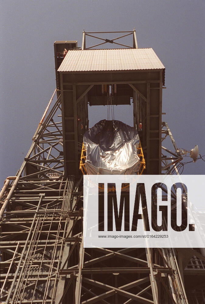A piece of the fairing that will cover the Mars Odyssey Orbiter during rises up the gantry at Launch Pad 17-A, Cape Canaveral Air Force Station. The 2001 Mars Odyssey Orbiter is scheduled for launch on a Delta rocket April 7, 2001. Mars Odyssey contains three science instruments: THEMIS, the Gamma Ray Spectrometer (GRS), and the Mars Radiation Environment Experiment (MARIE). THEMIS will map the mineralogy and morphology of the Martian surface using a high-resolution camera and a thermal infrared imaging spectrometer. The GRS will achieve global mapping of the elemental composition of the surface and determine the abundance of hydrogen in the shallow subsurface. The MARIE will characterize aspects of the near-space radiation environment with