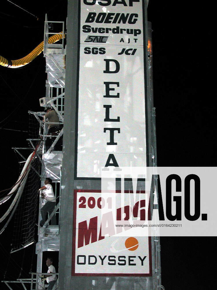 Signs on the side of the launch tower at Launch Complex 17, Cape Canaveral Air Force Station, show the nature of the impending launch. A worker on the side watches the umbilical connections to the Boeing Delta II rocket that is carrying the 2001 Mars Odyssey spacecraft. Liftoff is scheduled for 11:02 a.m. EDT from Launch Complex 17-A at Cape Canaveral Air Force Station. After an approximate 7-month journey, Mars Odyssey will orbit the planet Mars. The spacecraft, built by Lockheed Martin Space Systems for the Jet Propulsion Laboratory, will map the Martian surface looking for geological features that could indicate the presence of water, now or in the past. Science gathered by three science instruments on board will be key to future mission