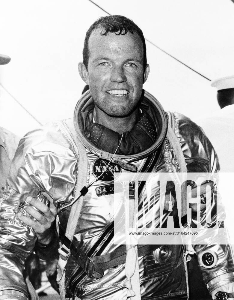 S63-07853 (16 May 1963) --- Astronaut L. Gordon Cooper Jr., pilot of the Mercury-Atlas 9 (MA-9) mission, stands supported by strong hands after climbing out of his spacecraft Faith 7 after a 600,000-mile, 22-orbit journey around Earth. He elected to remain in the spacecraft until it was hoisted to the deck of the USS Kearsarge, as did astronaut Walter Schirra during the previous mission.