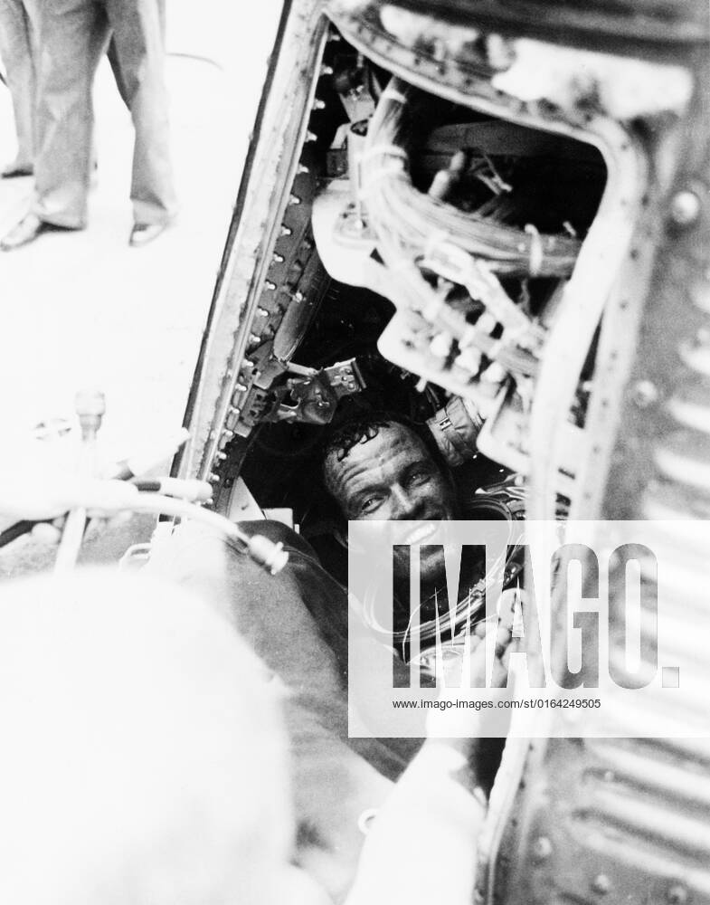 S63-07852 (16 May 1963)--- Astronaut L. Gordon Cooper Jr., pilot of the Mercury-Atlas 9 (MA-9) mission, has a smile for the recovery crew of the USS Kearsarge, after he is onboard from a successful 22-orbit mission of Earth in his spacecraft Faith 7 . Cooper is still sitting in his capsule, with his helmet off.