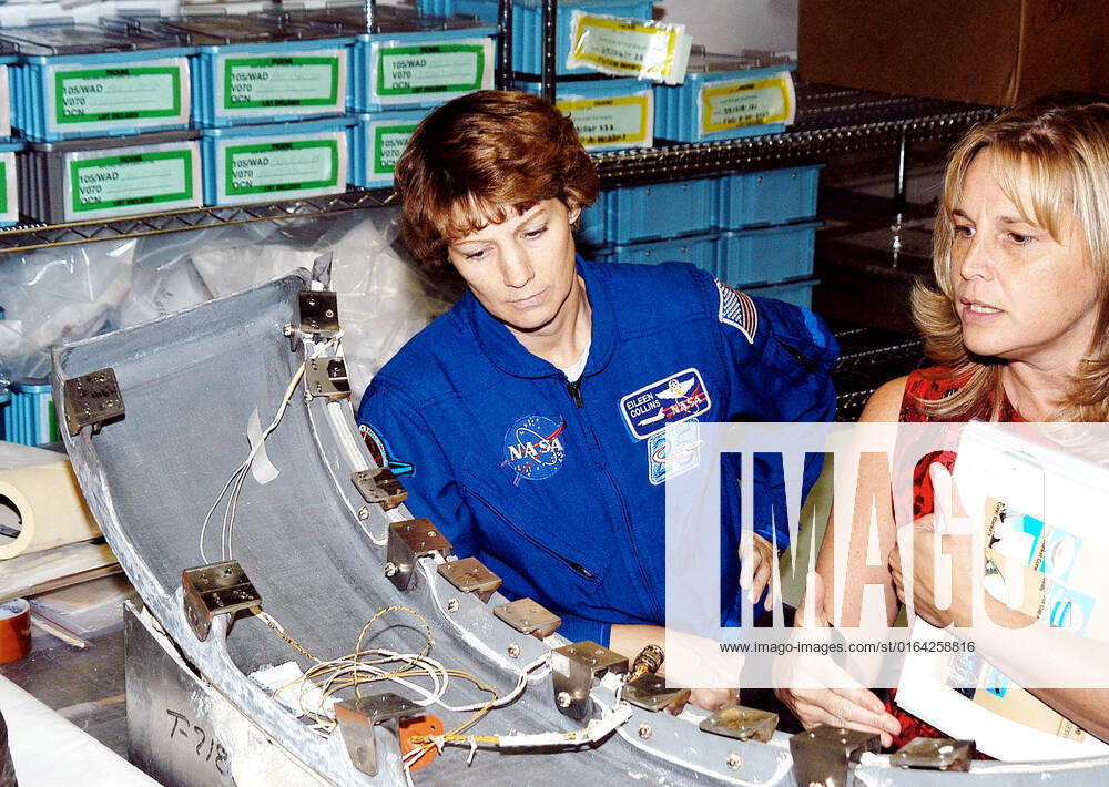 KENNEDY SPACE CENTER, FLA. - STS-114 Mission Commander Eileen Collins looks over flight equipment in the Orbiter Processing Facility, along with Glenda Laws, EVA Task Leader, with United Space Alliance at Johnson Space Center. The STS-114 crew is at KSC to take part in crew equipment and orbiter familiarization.