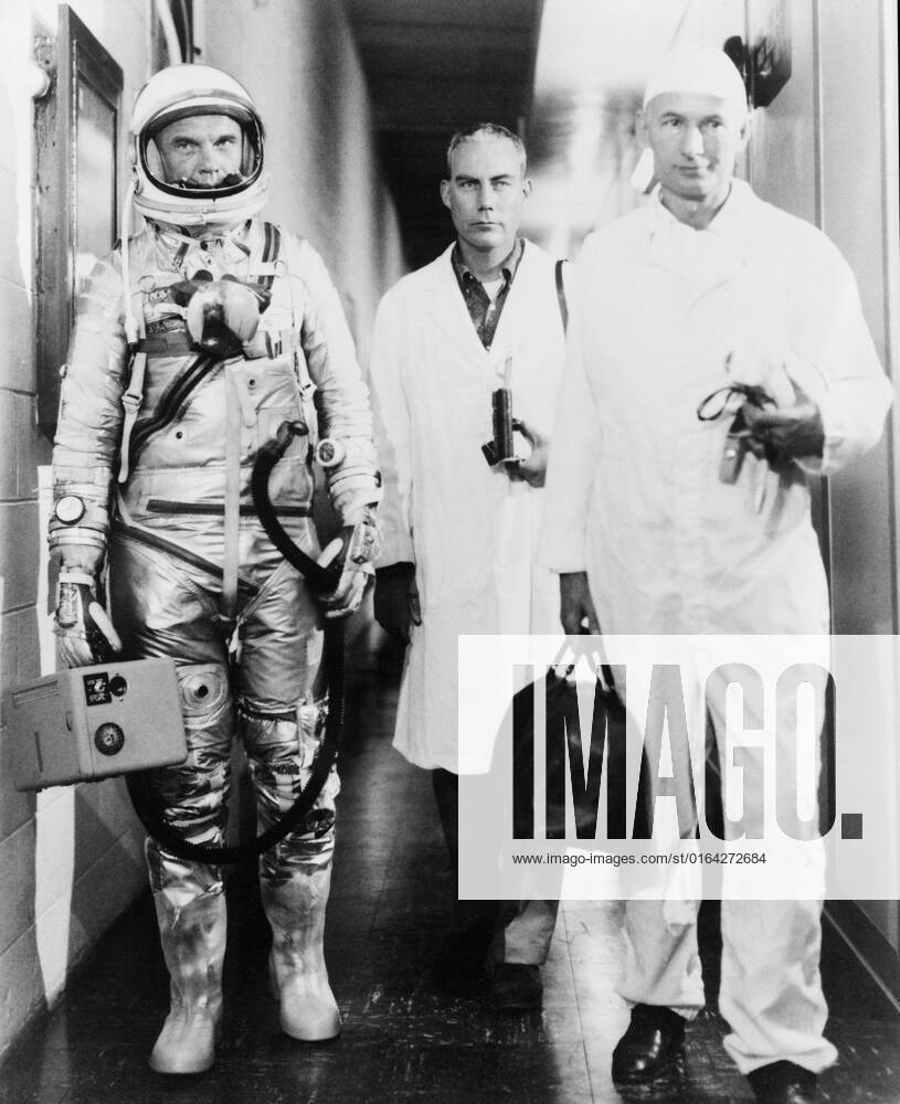 S62-00377 (20 Feb. 1962) --- Astronaut John H. Glenn Jr., walking out of building with Dr. William K. Douglas (to Glenn s left), and Joe W. Schmitt, NASA s suit technician (in front of Dr. Douglas). This Mercury Atlas 6 (MA-6) Friendship 7 flight marks America s first manned Earth-orbiting spaceflight.