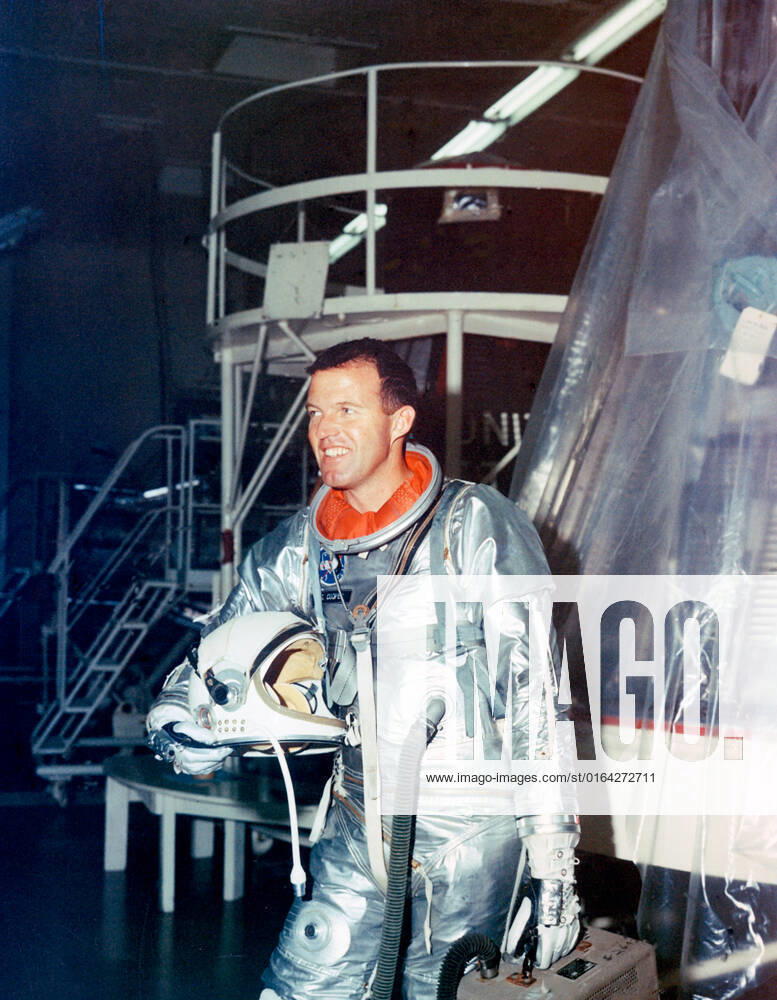 S63-01922 (1963) --- Astronaut L. Gordon Cooper Jr., pilot for the Mercury-Atlas 9 (MA-9) mission, stands fully suited beside his spacecraft during preflight testing. Cooper named his spacecraft the Faith 7.