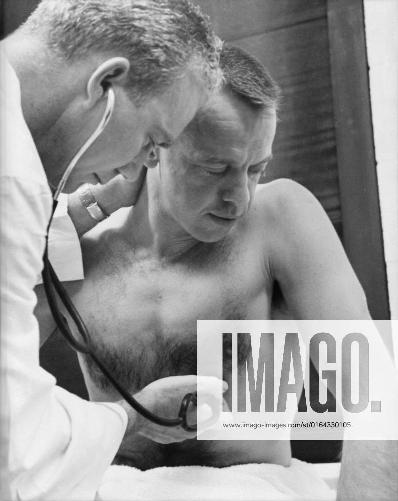 S61-02740 (5 May 1961) --- Astronaut Alan B. Shepard Jr. has his heart rate checked prior to his Mercury-Redstone 3 (MR-3) mission, the first American manned suborbital spaceflight. The attending physician is Dr. William K. Douglas.