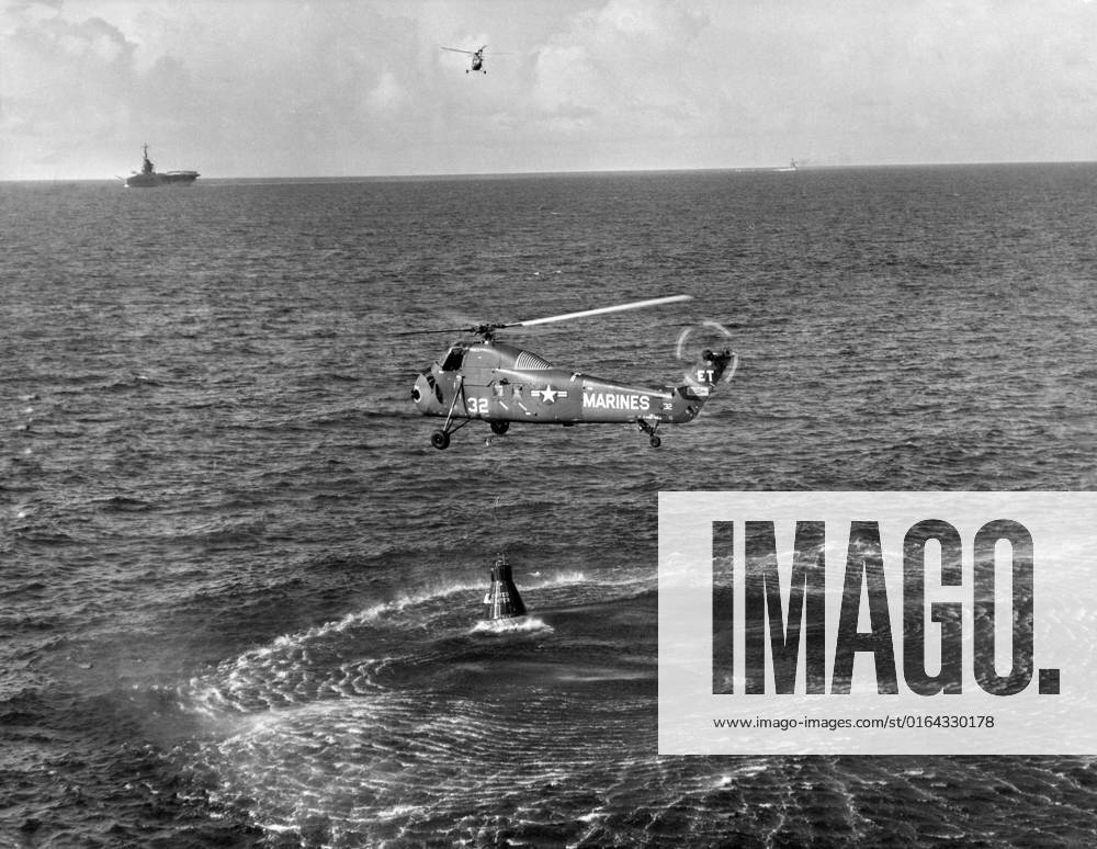 S61-02821 (21 July 1961) --- Attempted recovery of Mercury spacecraft at end of the Mercury-Redstone 4 (MR-4) mission. View shows the Marine helicopter dropping a recovery line to the capsule. In the upper left corner of the view, the recovery ship and another helicopter can be seen.