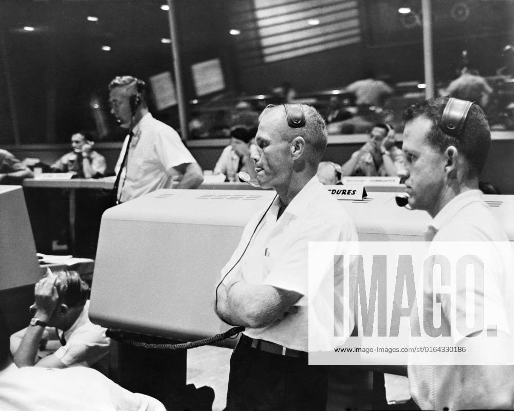 S61-03829 (21 July 1961) --- View of the Mission Control Center at Cape Canaveral during the Mercury-Redstone 4 (MR-4) mission. Astronauts John Glenn (left) and L. Gordon Cooper (right) act as spacecraft communicators (CAPCOM).