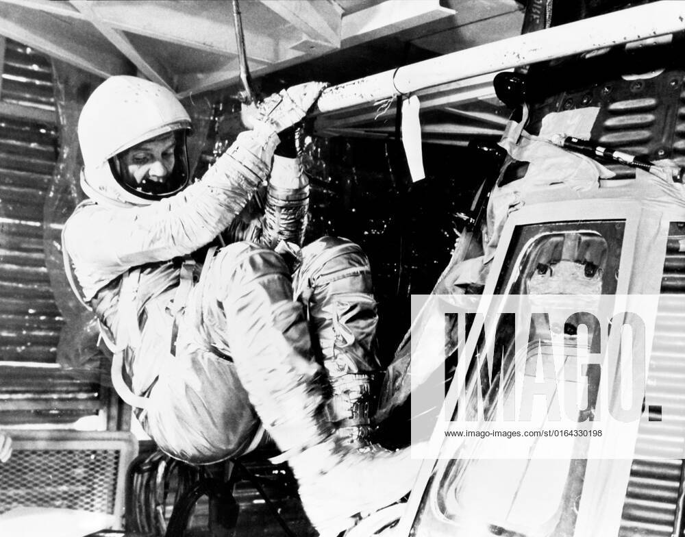 S62-00993 (1962) --- Astronaut John H. Glenn Jr., pilot of the Mercury-Atlas 6 (MA-6) mission, practices insertion into the Mercury Friendship 7 spacecraft during MA-6 preflight training activity at Cape Canaveral, Florida. He is wearing the full pressure suit and helmet.