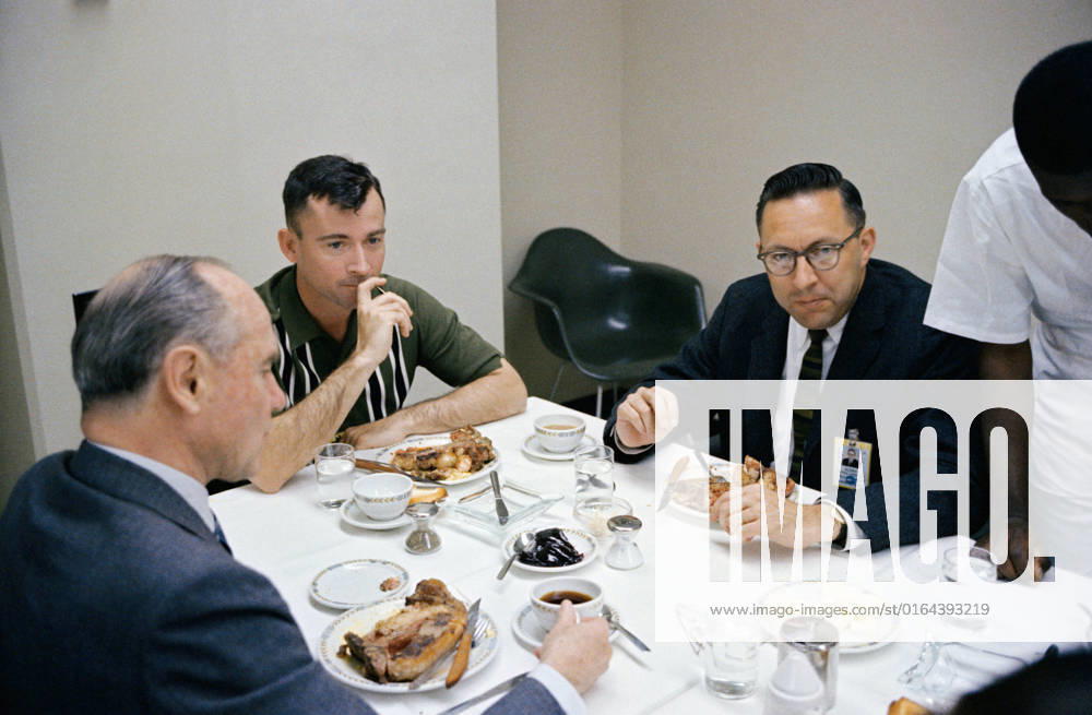 S65-20428 (23 March 1965) --- Astronaut John W. Young (center), pilot of the Gemini-Titan 3 flight, is shown during a steak breakfast which he was served about two hours prior to the 9 24 a.m. (EST) GT-3 launch. At left is J.S. McDonnell, board chairman and Chief Executive Officer of the McDonnell Aircraft Corporation. Dr. Charles A. Berry, chief of Center Medical Programs, is at right.