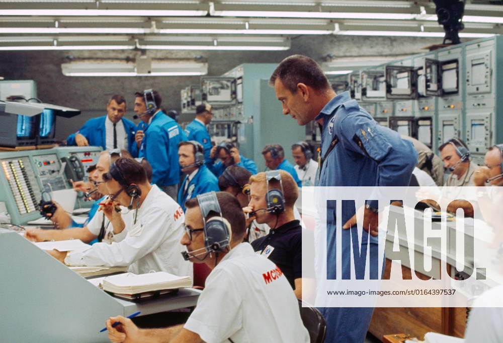 S65-28742 (21 Aug. 1965) --- View of Mission Control Center at Cape Kennedy, Florida, moments after the Gemini-5 spacecraft was launched from Pad 19 on Aug. 21, 1965. Standing at right is astronaut Donald K. Slayton, assistant director for Flight Crew Operations, Manned Spacecraft Center. Seated (wearing dark shirt) is astronaut Russell L. Schweickart. Other NASA and McDonnell Aircraft Col. personnel also monitor the progress of the flight.