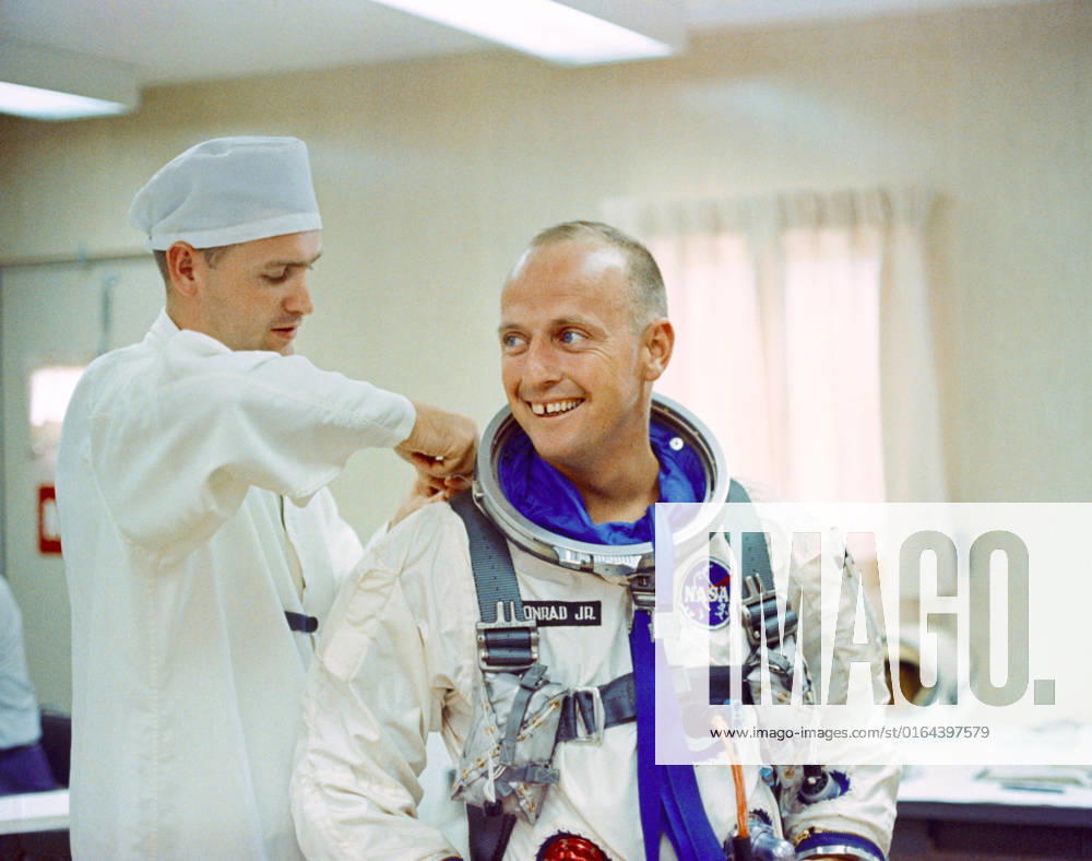 S65-41955 (12 July 1965) --- Astronaut Charles Conrad Jr. receives assistance with his pressure suit during suiting up and ingress test activity at Pad 16, Cape Kennedy, Florida in preparation for the Gemini-5 spaceflight.
