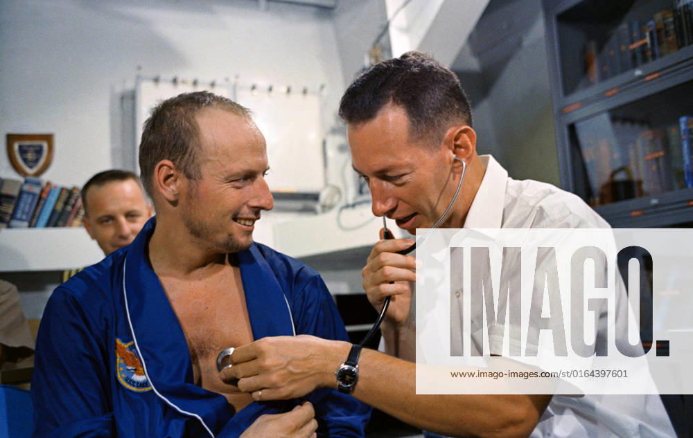 S65-46634 (29 Aug. 1965) --- Astronaut Charles Conrad Jr. has his heart rate checked by a physician after the Gemini-5 mission.