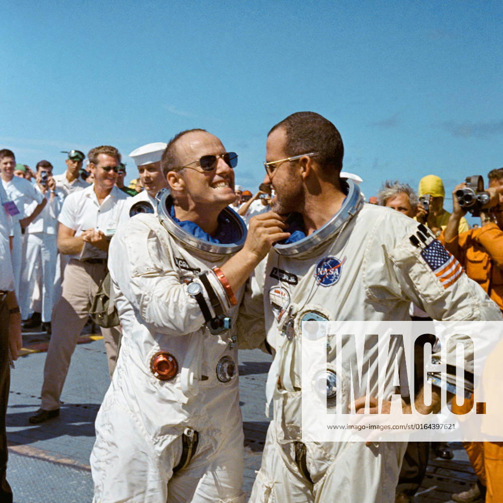 S65-46638 (29 Aug. 1965) --- Astronaut Charles Conrad Jr. tweaks astronaut L. Gordon Cooper s eight-day growth of beard for the cameramen while onboard the prime recovery vessel after their Gemini-5 flight.
