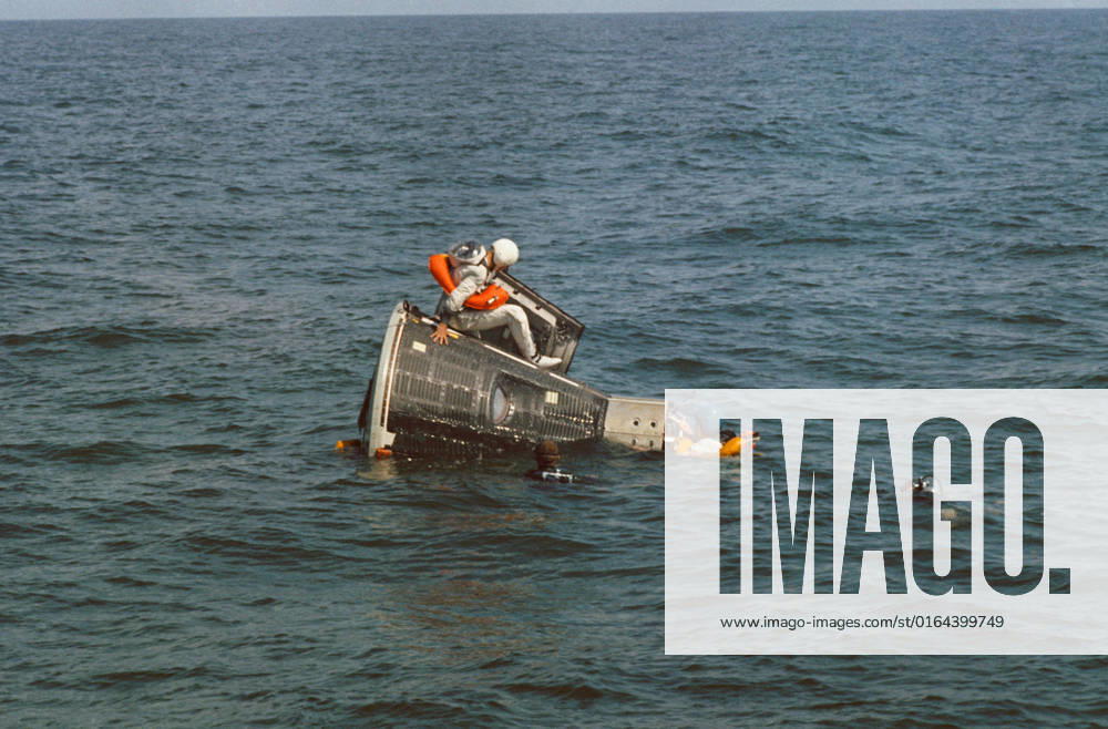 S65-55562 (15 Oct. 1965) --- Astronaut James A. Lovell Jr., prime crew pilot for the Gemini-7 spaceflight, sits on top of the Gemini spacecraft Static Test Article during water egress training in the Gulf of Mexico. Astronaut Frank Borman (wearing blue helmet), prime crew command pilot, hangs onto the nose of the spacecraft. NASA divers are in the water as a safety precaution.