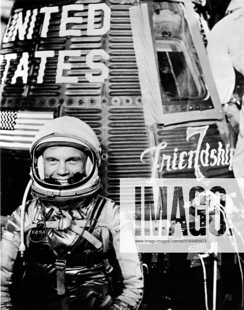 62-MA6-55 (1962) --- Astronaut John H. Glenn Jr., pilot of the Mercury Atlas 6 (MA-6) spaceflight, poses for a photo with the Mercury Friendship 7 spacecraft during preflight activities.