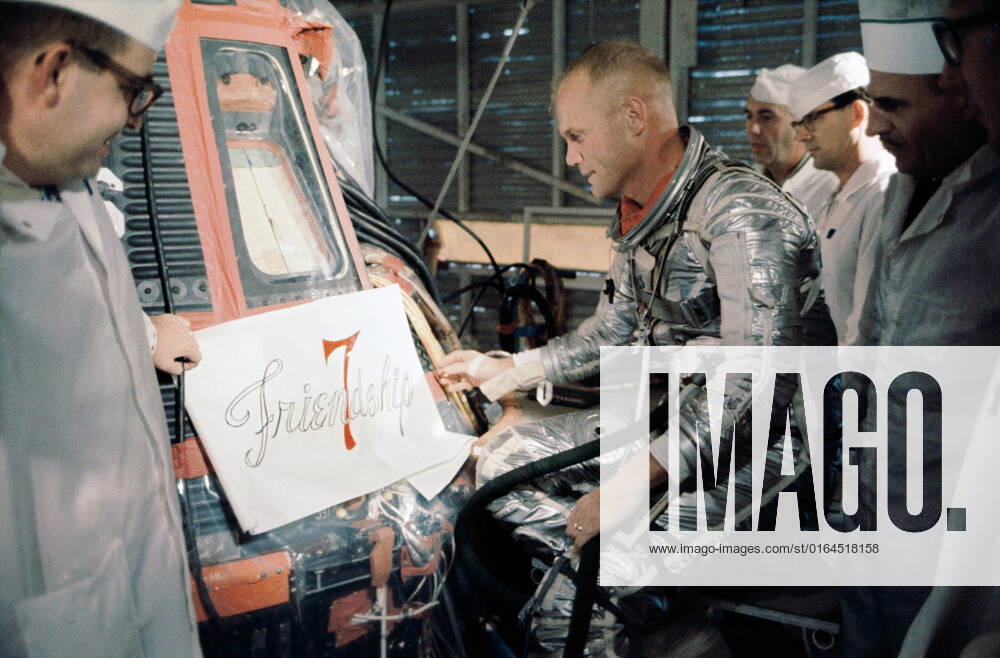 S64-14854 (20 Feb. 1962) --- Astronaut John H. Glenn Jr. and technicians inspect a decal ready for application to the side of his Mercury spacecraft prior to launch on Feb. 20, 1962. The decal reads Friendship 7 .