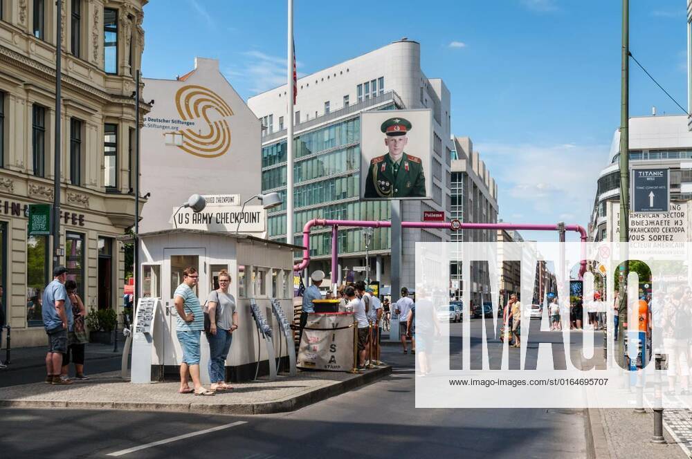 Tourists on the street near the Checkpoint Charlie in Berlin. Checkpoint Charlie famous passage between the West and East Berlin during the Cold War., Berlin, Germany - May 28, 2017: Tourists on the street near the Checkpoint Charlie in Berlin. Checkpoint Charlie famous passage between the West and East Berlin during the Cold War., 20.07.2020,