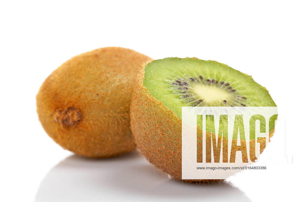 Two half of kiwi fruit reflected on white background. Shallow DOF