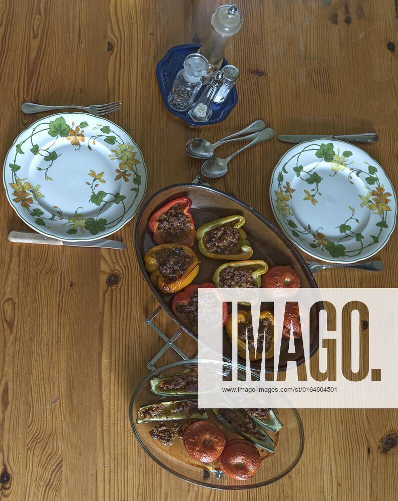 Filled Peppers and Tomatoes in Two Casseroles at the dining table, Bavaria, Germany, Europe