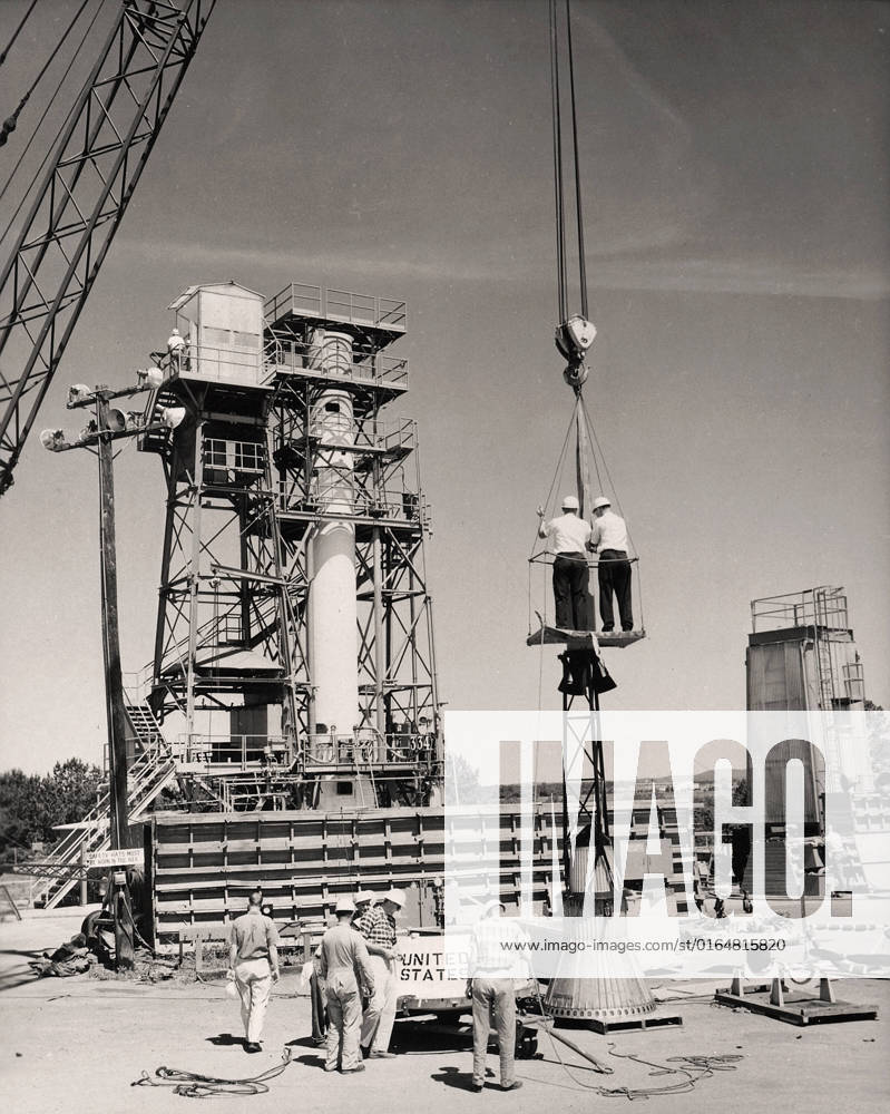 This photograph shows the installation of a Mercury capsule and escape system on top of a booster prior to test firing of the Mercury-Redstone at Marshall Space Flight Center s (MSFC s) Redstone Test Stand. Assembled by MSFC, the Mercury-Redstone was designed to place a marned space capsule in orbital flight around the Earth and recover both safely.