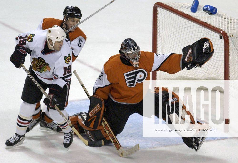 Feb. 27, 2003 - U.S. - KRT SPORTS STORY SLUGGED: BLACKHAWKS-FLYERS KRT PHOTO BY JERRY LODRIGUSS PHILADELPHIA INQUIRER (February 27) PHILADELPHIA, PA -- Philadelphia goalie Roman Cechmanek makes a save with the glove as Chicago s Kyle Calder, left, is defended by Kim Johnsson on Thursday, February 27, 2003. (gsb) 2003 News Archive - Feb. 27, 2003 - ZUMAm67