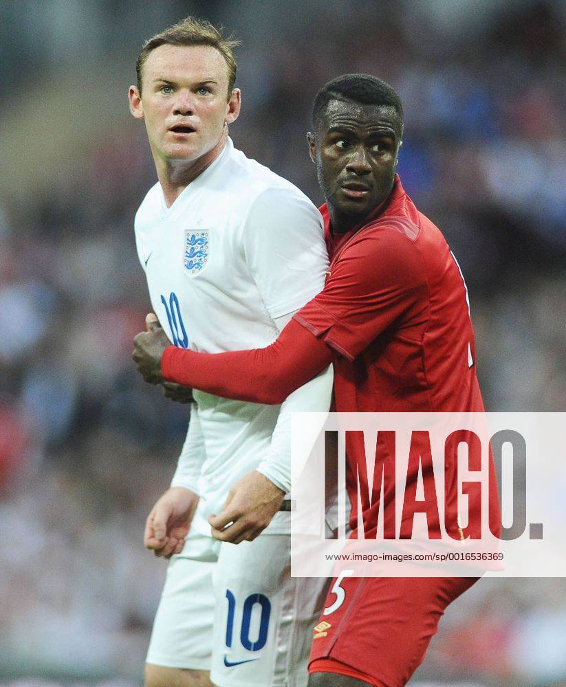 Football - 2014 International Friendly - England vs. Peru England s Wayne Rooney is grabbed by Peru s Christian Ramos at Wembley. COLORSPORT ANDREW COWIE
